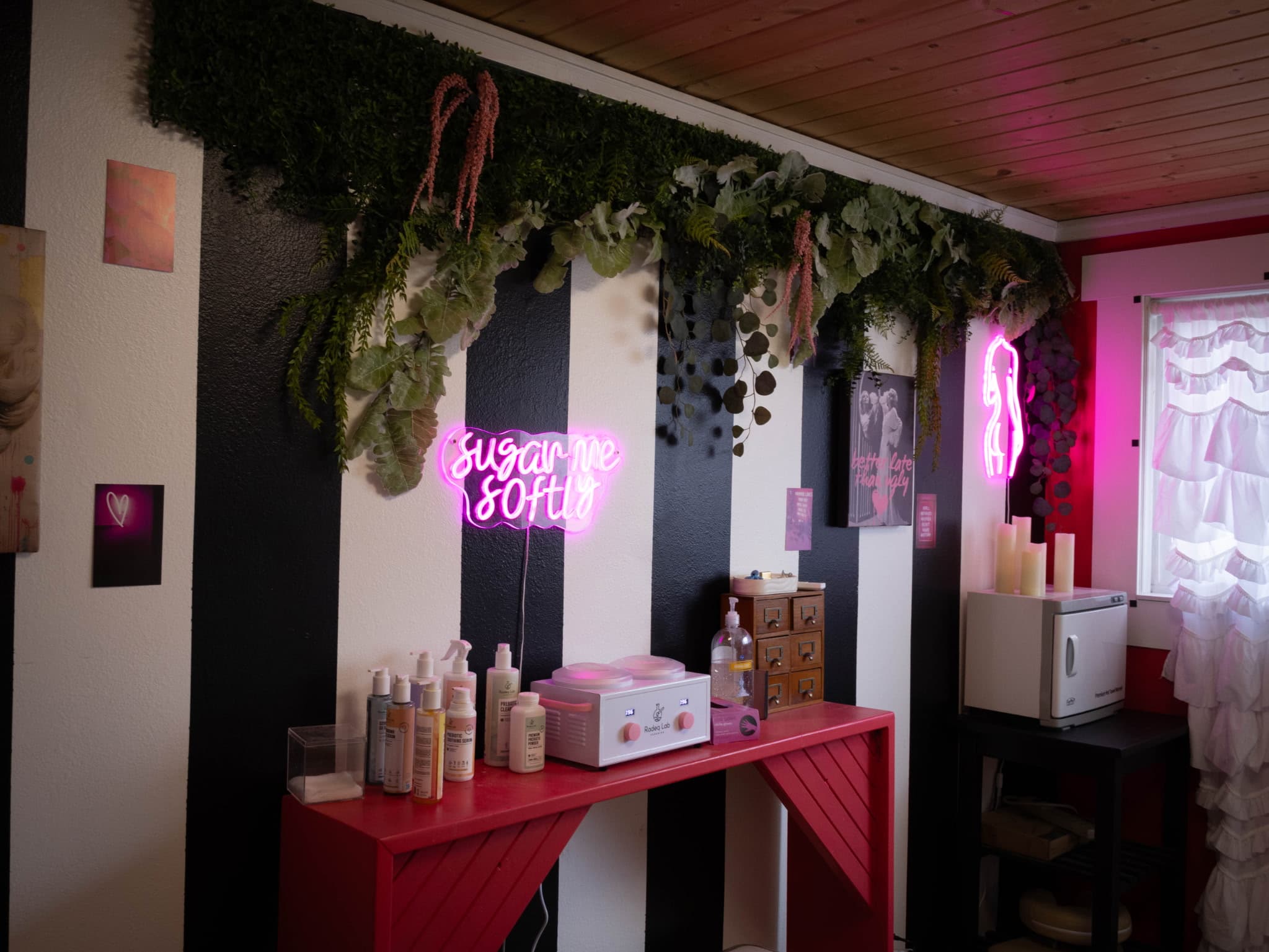 Salon interior with neon signs and black and white stripes